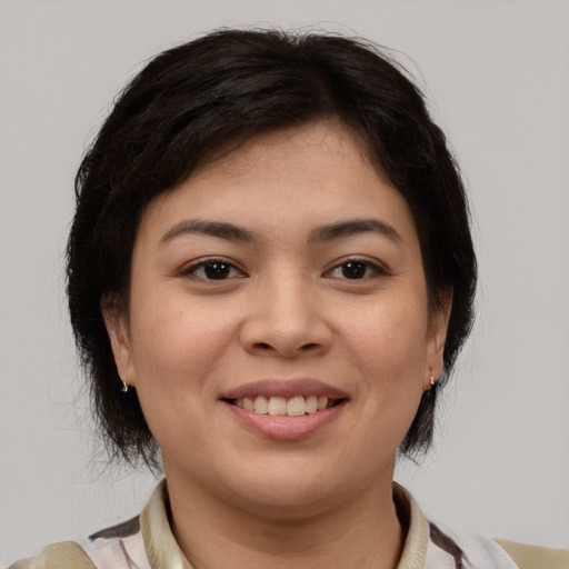 Joyful asian young-adult female with medium  brown hair and brown eyes