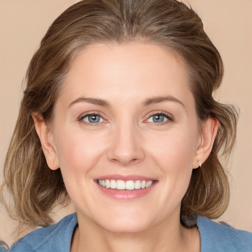 Joyful white adult female with medium  brown hair and grey eyes