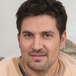 Joyful white adult male with short  brown hair and brown eyes