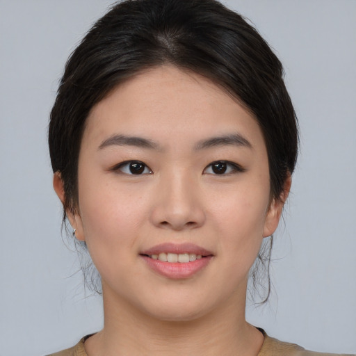 Joyful asian young-adult female with medium  brown hair and brown eyes