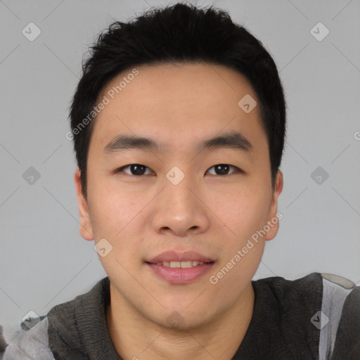 Joyful asian young-adult male with short  black hair and brown eyes