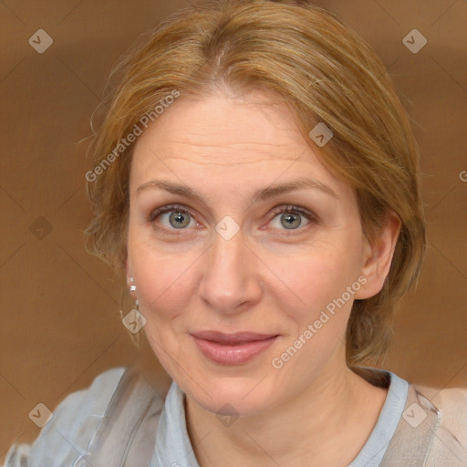 Joyful white adult female with medium  brown hair and blue eyes