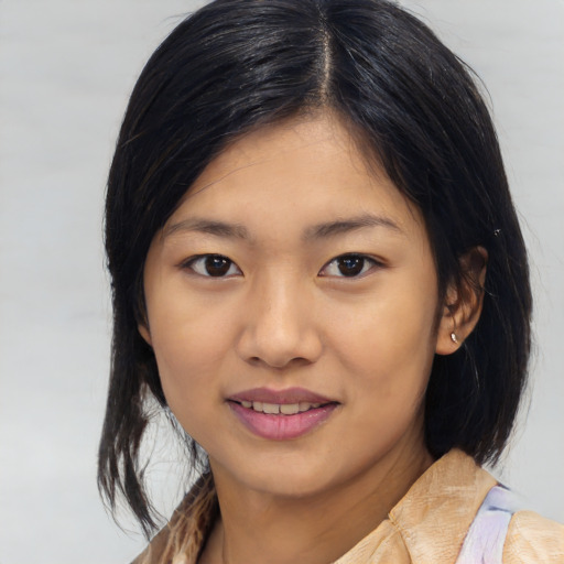Joyful asian young-adult female with medium  black hair and brown eyes