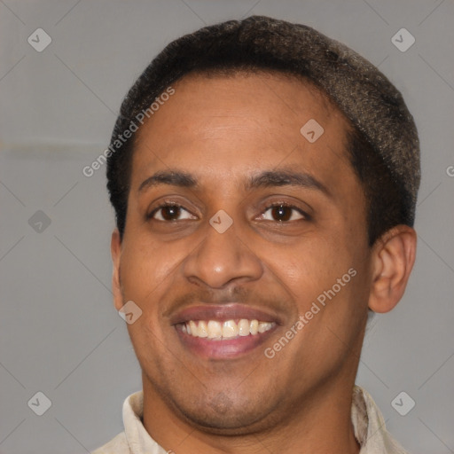 Joyful black young-adult male with short  brown hair and brown eyes