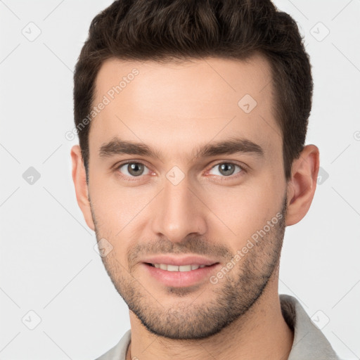 Joyful white young-adult male with short  brown hair and brown eyes