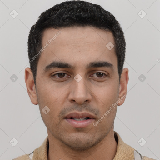 Joyful white young-adult male with short  black hair and brown eyes