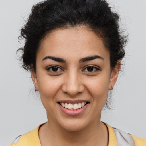 Joyful latino young-adult female with short  brown hair and brown eyes