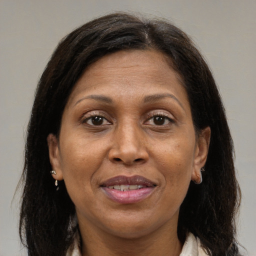 Joyful black adult female with medium  brown hair and brown eyes