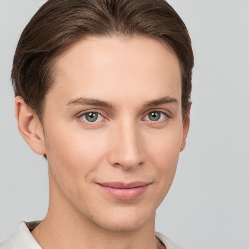 Joyful white young-adult female with short  brown hair and grey eyes