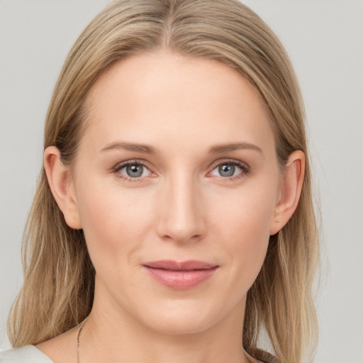 Joyful white young-adult female with long  brown hair and blue eyes