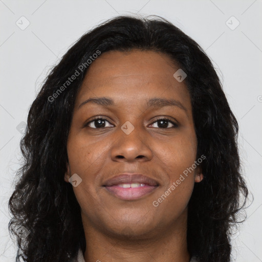 Joyful black young-adult female with long  brown hair and brown eyes