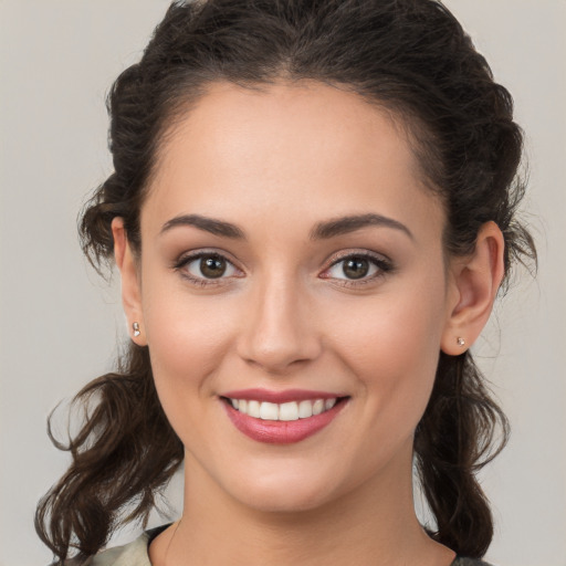 Joyful white young-adult female with medium  brown hair and brown eyes