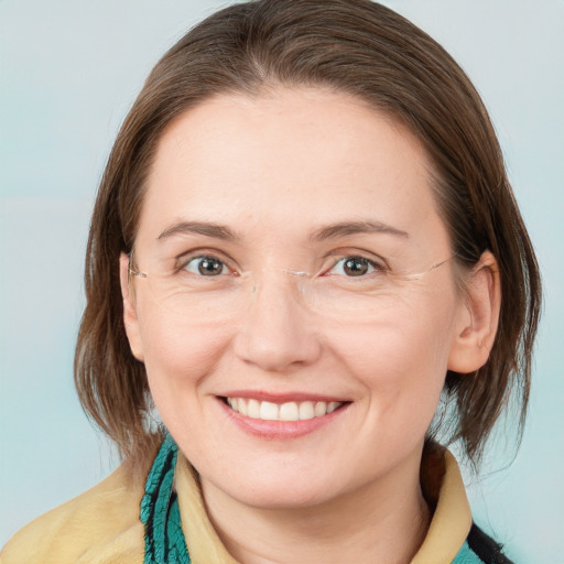 Joyful white young-adult female with medium  brown hair and blue eyes