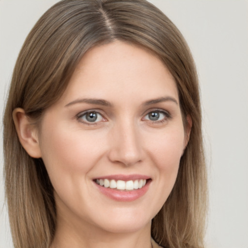 Joyful white young-adult female with long  brown hair and grey eyes