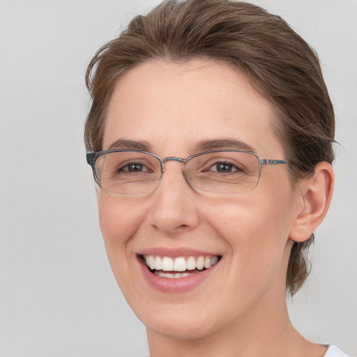 Joyful white adult female with medium  brown hair and grey eyes