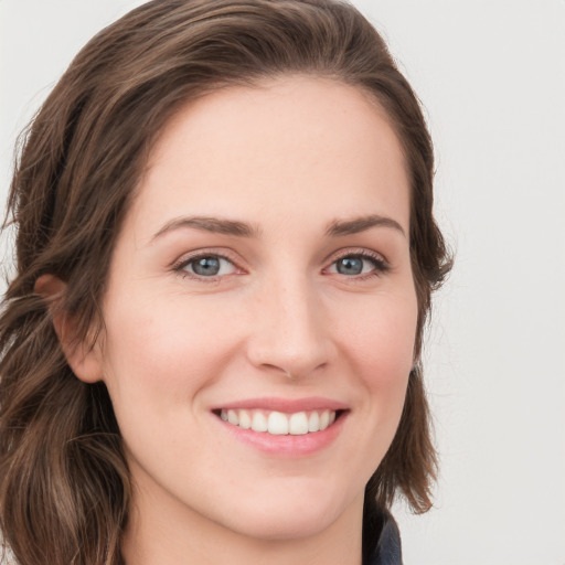 Joyful white young-adult female with long  brown hair and green eyes