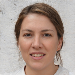 Joyful white young-adult female with medium  brown hair and brown eyes