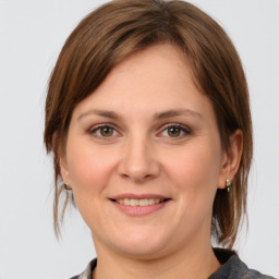 Joyful white young-adult female with medium  brown hair and grey eyes