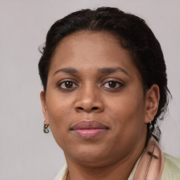 Joyful black young-adult female with short  brown hair and brown eyes