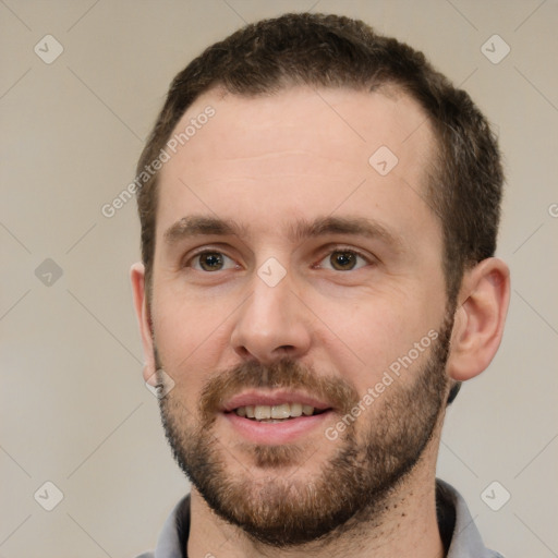 Joyful white young-adult male with short  brown hair and grey eyes