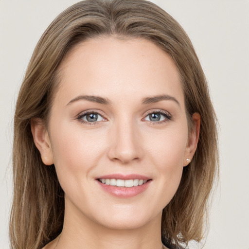 Joyful white young-adult female with long  brown hair and grey eyes