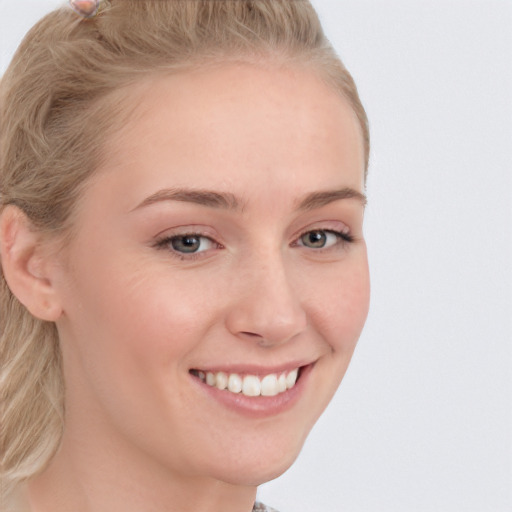 Joyful white young-adult female with long  brown hair and blue eyes