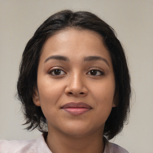 Joyful latino young-adult female with medium  brown hair and brown eyes