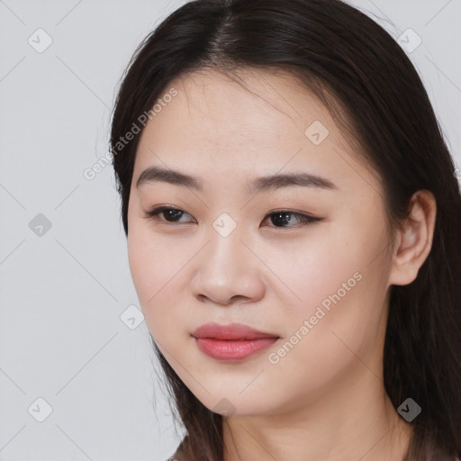 Joyful asian young-adult female with long  brown hair and brown eyes