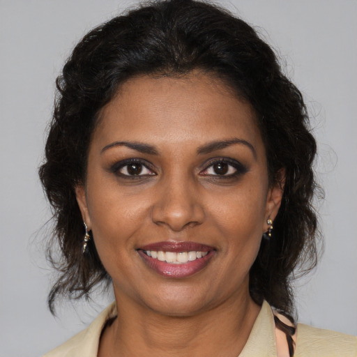Joyful black young-adult female with medium  brown hair and brown eyes
