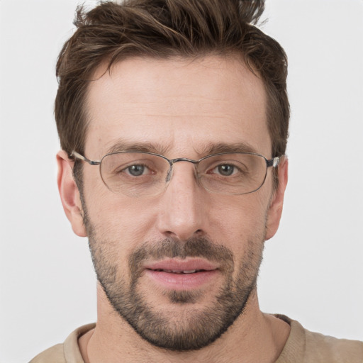 Joyful white adult male with short  brown hair and grey eyes