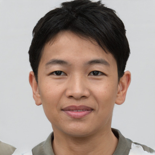 Joyful asian young-adult male with short  black hair and brown eyes