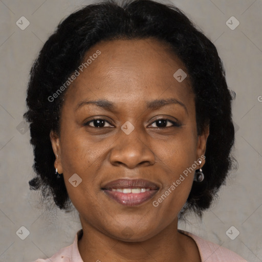 Joyful black adult female with medium  brown hair and brown eyes