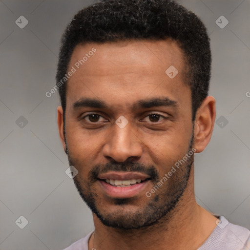 Joyful black young-adult male with short  black hair and brown eyes