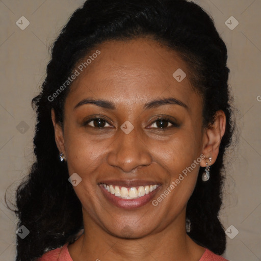 Joyful black young-adult female with long  brown hair and brown eyes