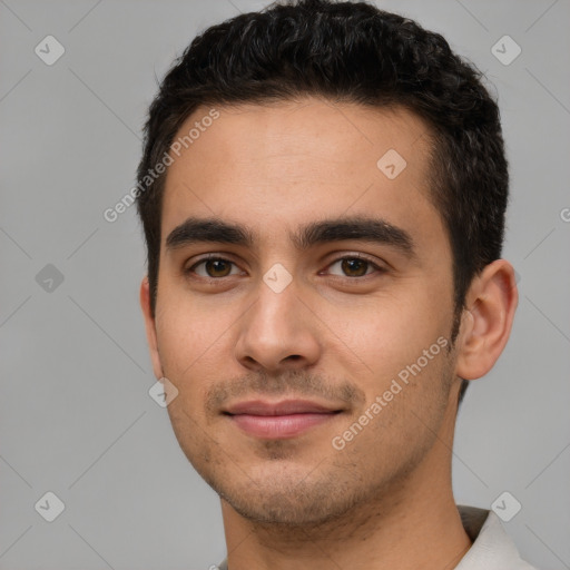 Joyful white young-adult male with short  black hair and brown eyes