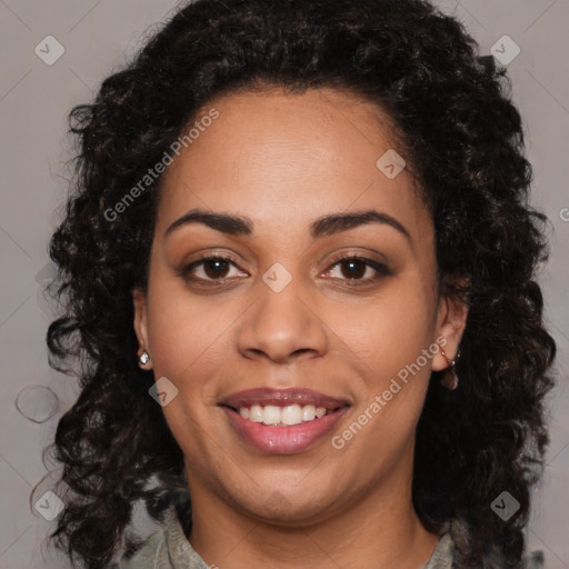 Joyful black young-adult female with long  brown hair and brown eyes