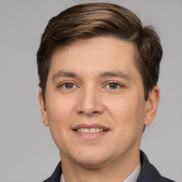 Joyful white young-adult male with short  brown hair and brown eyes