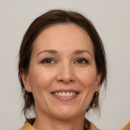 Joyful white adult female with medium  brown hair and brown eyes