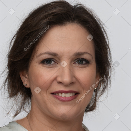 Joyful white adult female with medium  brown hair and brown eyes