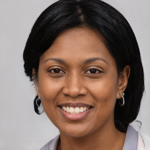 Joyful asian adult female with medium  black hair and brown eyes