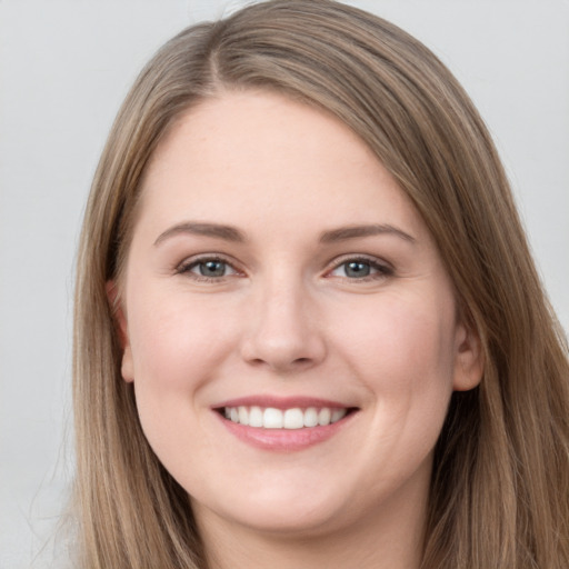 Joyful white young-adult female with long  brown hair and grey eyes