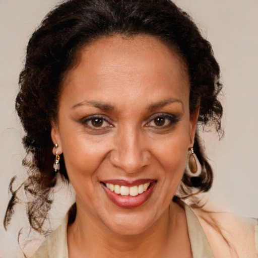 Joyful black adult female with medium  brown hair and brown eyes