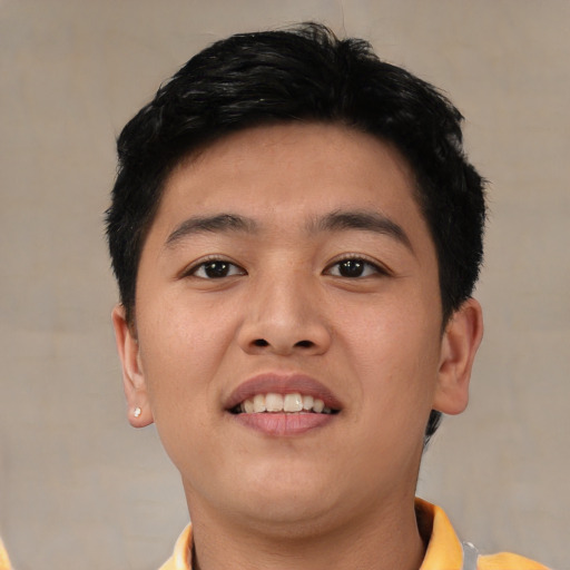 Joyful asian young-adult male with short  black hair and brown eyes