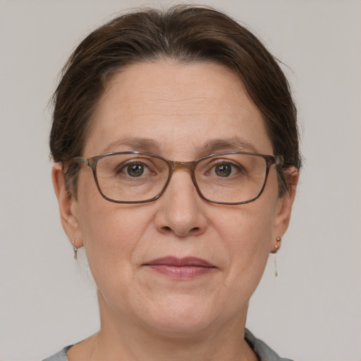 Joyful white adult female with short  brown hair and grey eyes