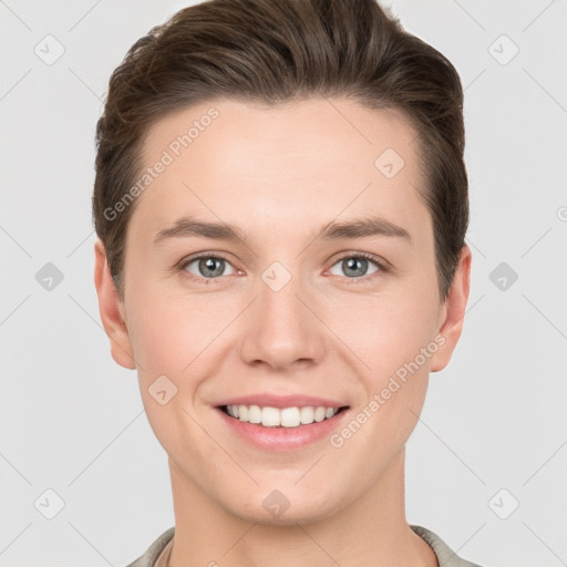 Joyful white young-adult female with short  brown hair and grey eyes