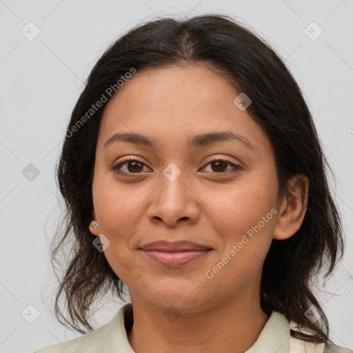 Joyful latino adult female with medium  brown hair and brown eyes