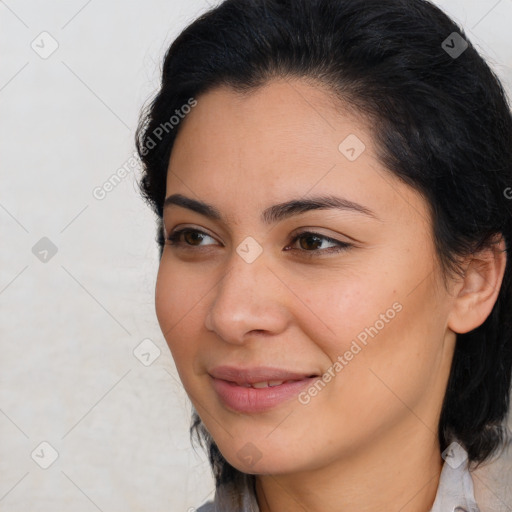 Joyful latino young-adult female with medium  brown hair and brown eyes