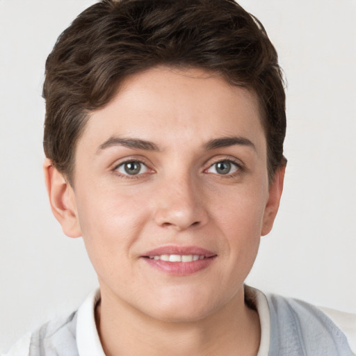 Joyful white young-adult female with short  brown hair and grey eyes