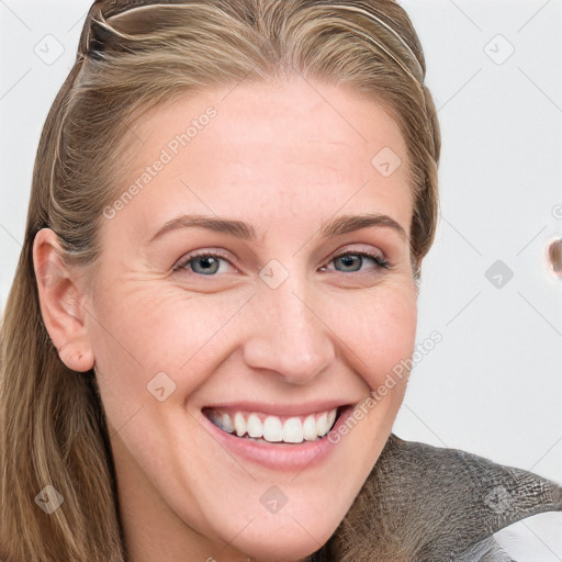 Joyful white young-adult female with long  brown hair and blue eyes