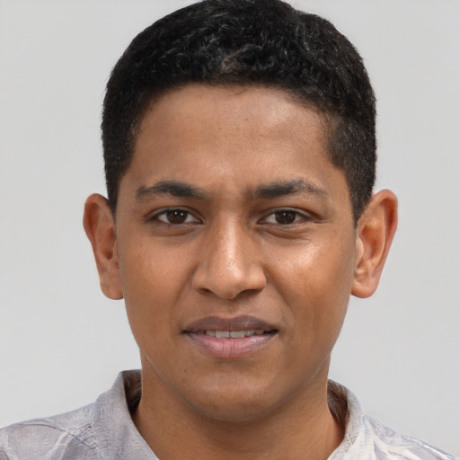 Joyful black young-adult male with short  black hair and brown eyes